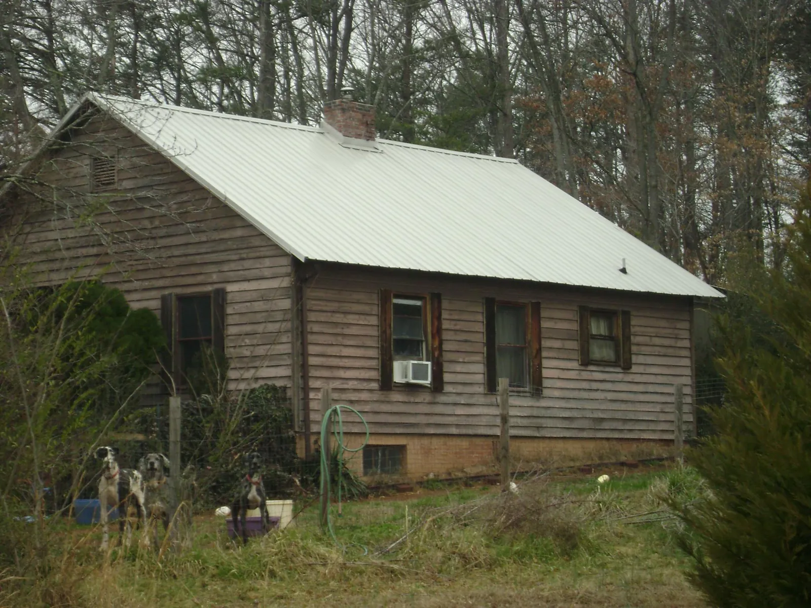 White metal roof on an old wood sided farmhouse, from a Metal Roof Installation job in Van Wert